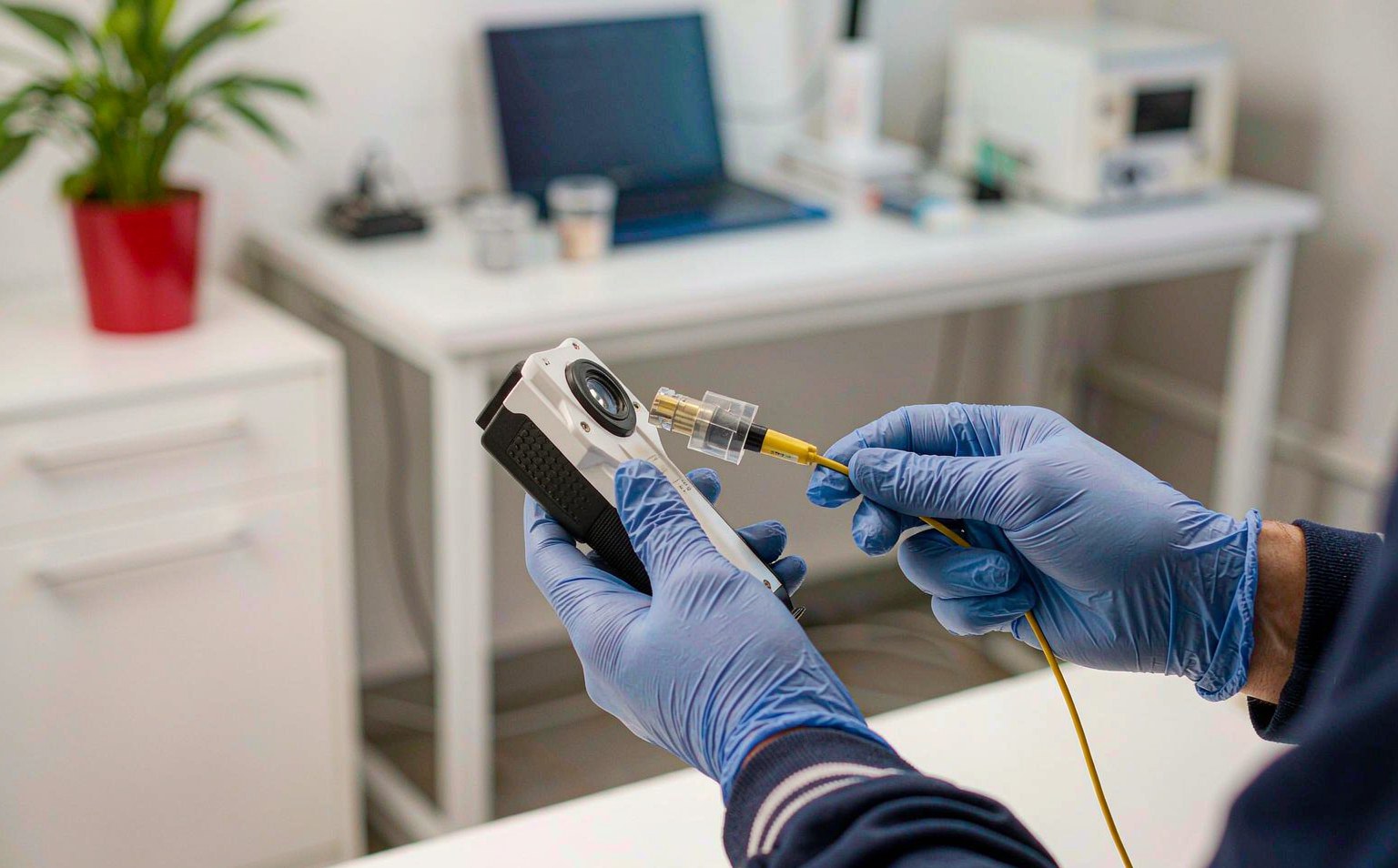 Technician inspecting a connector between controlled mating cycles