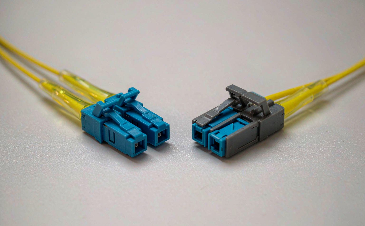LC uniboot connector with push pull tab beside a standard LC duplex connector